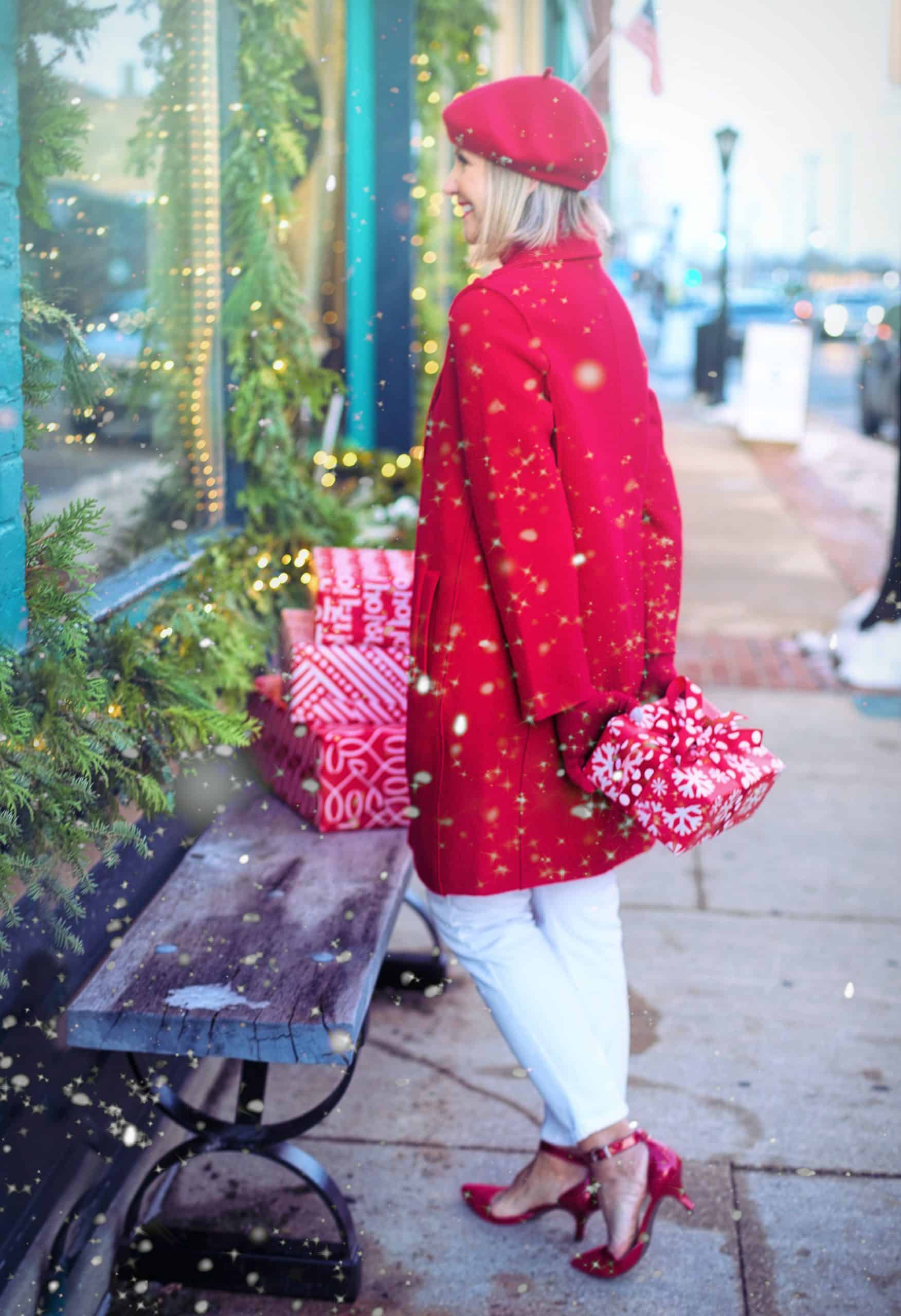 Women outside a store during winter wearing a red coat.
